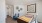 a room with a desk and chairs